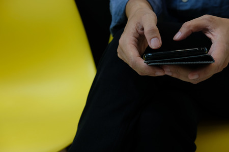 businessman using smartphone at home. man with mobile phone in cafe coffee shop cafeteria. people lifestyleの写真素材