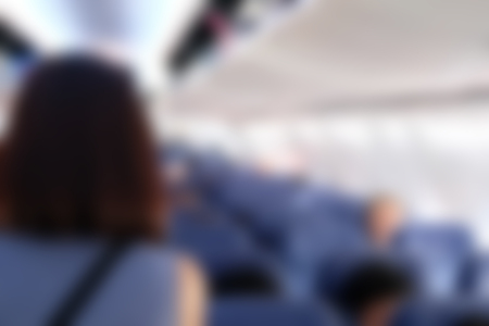 passenger in airplane. aeroplane interior. blurry defocused backgroundの写真素材