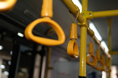 yellow handle on commuter bus at night. public transportの写真素材