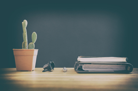 cactus plant eyeglasses & notebook on office desk at workplaceの写真素材