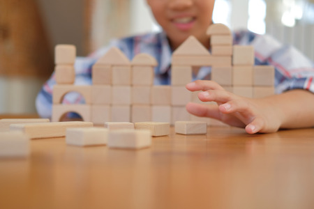young little asian kid boy child children schoolboy playing wood block toy. learning education conceptの写真素材