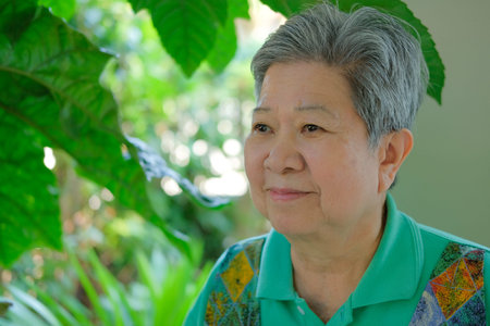 elder woman resting in park. asian elderly female relaxing outdoors. senior leisure lifestyle