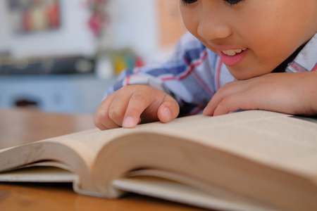 young little asian kid boy child children schoolboy studying reading book. childhood educationの写真素材