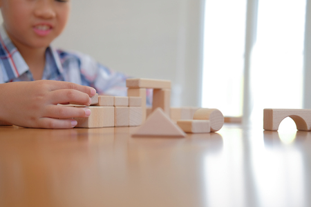 young little asian kid boy child children schoolboy playing wood block toy. learning education conceptの写真素材