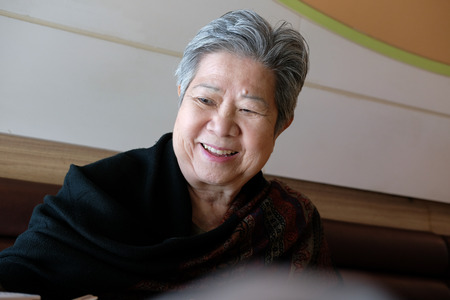 old elderly elder woman eating food in restaurant. senior lifestyle conceptの写真素材