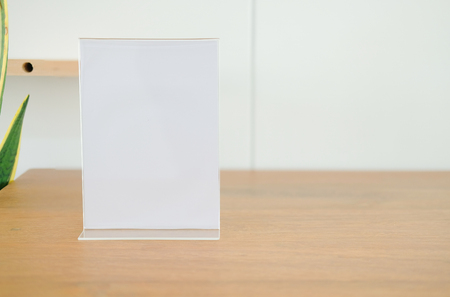 white label in cafe. display stand for acrylic tent card in coffee shop. mockup menu frame on table in restaurant. space for textの写真素材