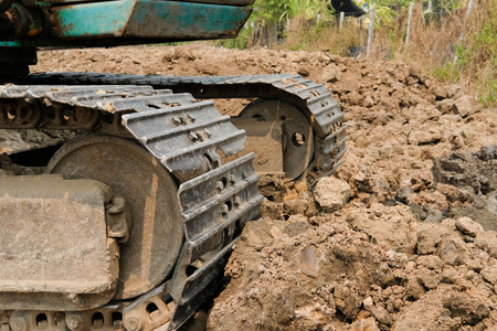 excavator backhoe digger tractor at construction siteの写真素材