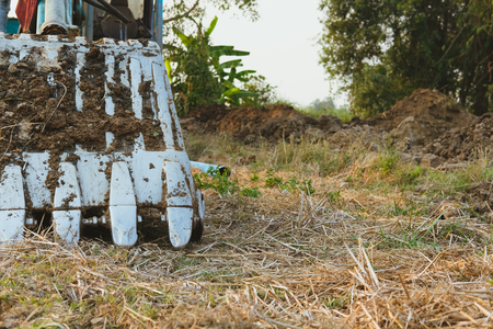 excavator backhoe digger tractor at construction siteの写真素材