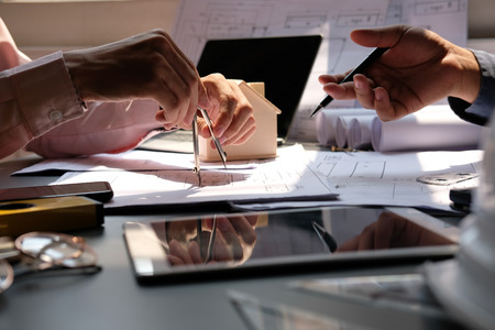 architect engineer team working on house blueprint of real estate project at workplace. building construction teamwork conceptの写真素材