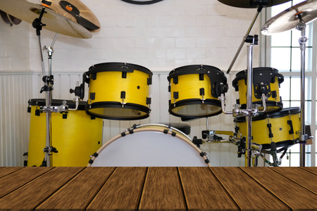 yellow drum. musical purcussion instrument with wood table for display productの写真素材