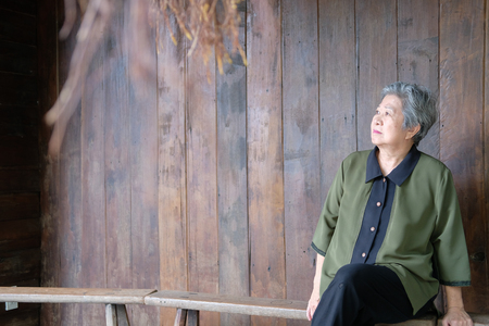 old elder woman sitting at home. elderly female relaxing outdoors. senior leisure lifestyleの写真素材