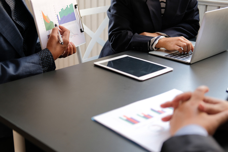 financial adviser discussing with investor. business people have a meeting. businessman working on startup project with co-worker team.の写真素材