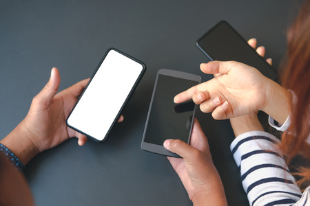 business people discussing using smart mobile phone smartphoneの写真素材