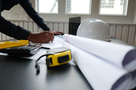 architect engineer working on house blueprint of real estate project at workplace. building construction conceptの写真素材