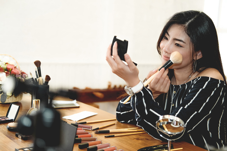 asian woman applying makeup cosmetic. make up beauty conceptの写真素材