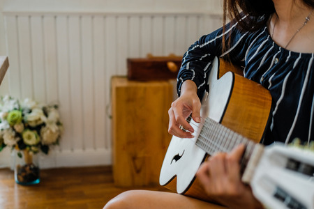 woman playing guitar at home.  leisure lifestyle conceptの写真素材