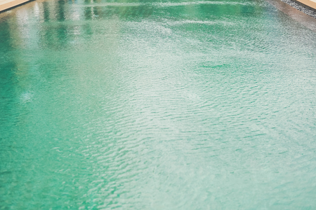 water surface of green swimming pool in hotelの写真素材