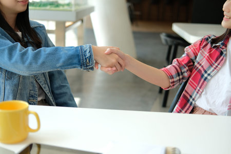 asian girl teenager friends shaking hands for startup project. teamwork, friendship conceptの写真素材