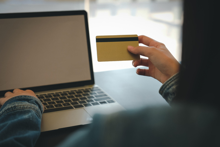 woman holding credit card using computer for shopping onlineの写真素材
