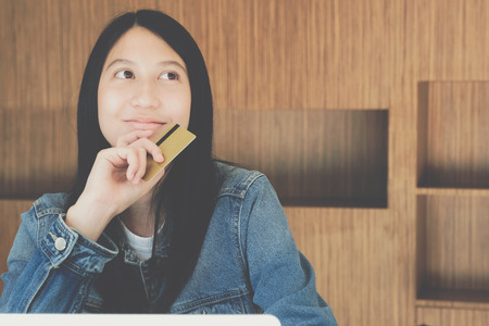 woman holding credit card using computer for shopping onlineの写真素材