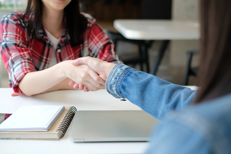 asian girl teenager friends shaking hands for startup project. teamwork, friendship conceptの写真素材