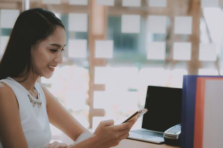 woman holding mobile smart phone using app text messageの写真素材