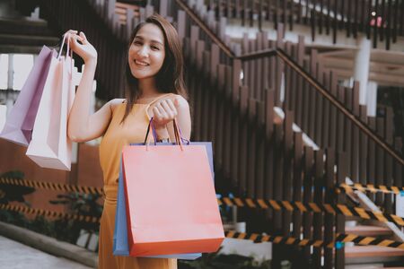 woman holding shopping bags. consumerism shopaholic lifestyle in mallの写真素材