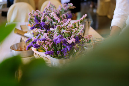 man florist arranging flower decoration for banquet in flora shopの写真素材