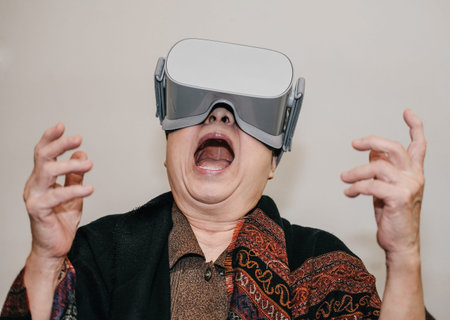 old asian senior woman wearing virtual reality goggles. VR headset device