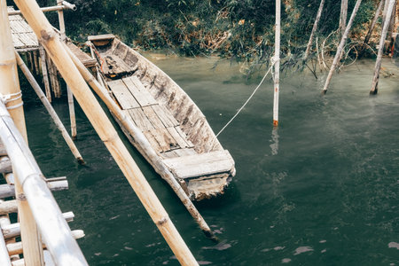 old wooden boat parking in river lake
