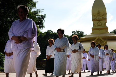 Ubonratchatani, Thailand -  July 9, 2019: buddhist people walking for meditation in Chiang Mai university in Nongpapong temple in Ubonratchatani, Thailand on July 9, 2019.のeditorial素材