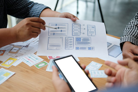 user experience UX designer designing web on smart phone layout. UI planning mobile application....