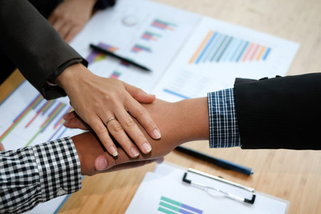 businessman joining united hand, business team touching hands together after complete a deal in...