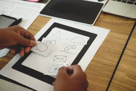 user experience UX designer designing web on smart phone layout. UI planning mobile application. developer work with business prototypeの写真素材