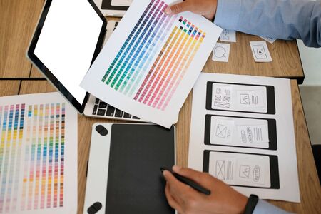 user experience UX designer designing web on smart phone layout. UI planning mobile application. developer work with business prototypeの写真素材