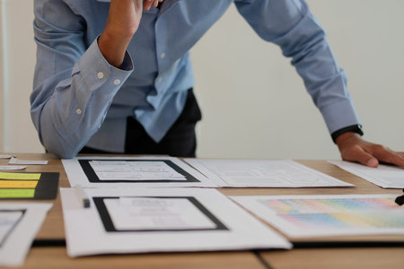 user experience UX designer designing web on smart phone layout. UI planning mobile application....