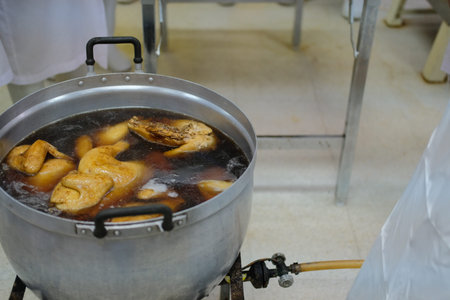 chicken boiling in fish sauce soup. boiled braised chicken