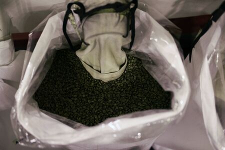 green unroasted coffee bean in sack in food factory industryの写真素材