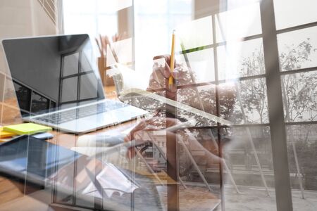 designer working on graphic tablet discussing creative idea of startup project with partnerの写真素材