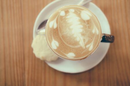 hot cappuccino coffee latte on wood table. delicious beverageの写真素材