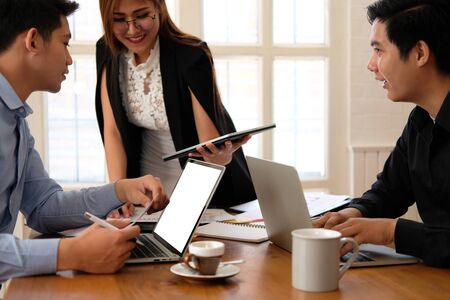 executive businesswoman advising analyzing discussing business project with co-worker teamの写真素材