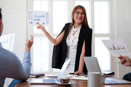 executive businesswoman advising analyzing discussing business project with co-worker teamの写真素材