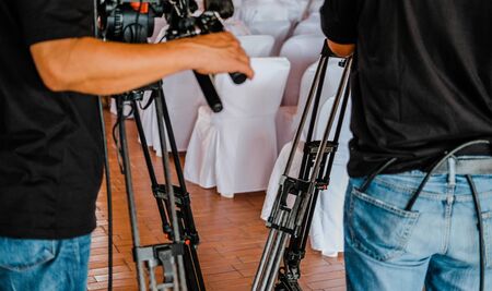 professional video production camera recording live event on stage. television social media broadcasting seminar conference.の写真素材