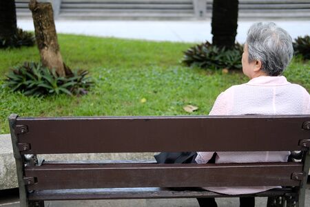 old elder woman resting in garden. asian elderly female relaxing outdoors. senior leisure lifestyleの写真素材