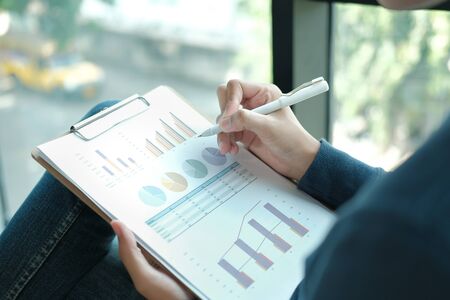 startup male freelancer working with document at office. man entrepreneur analyzing financial performance at workplace. student studying doing assignmentの写真素材