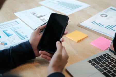male freelancer using mobile smart phone. startup man entrepreneur working at workplace.の写真素材