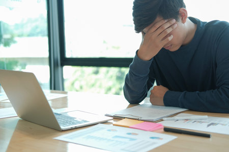 man feeling tired, frustrated & stressed from hard work. exhausted freelancer have headache at...