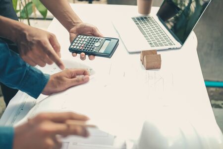 architect engineer working on house blueprint of real estate project at workplace. building construction conceptの写真素材