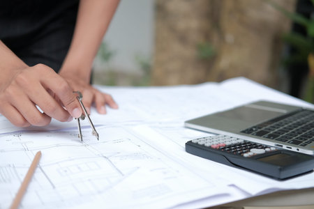 architect engineer working on house blueprint of real estate project at workplace. building...