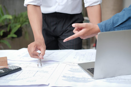 architect engineer working on house blueprint of real estate project at workplace. building...